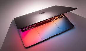 Partially open MacBook glowing red and blue